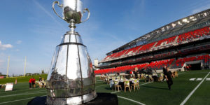 gourmet-GridIron-gallery3-600x300 The Grey Cup in front of the dinner setting at the Gourmet on the Gridiron